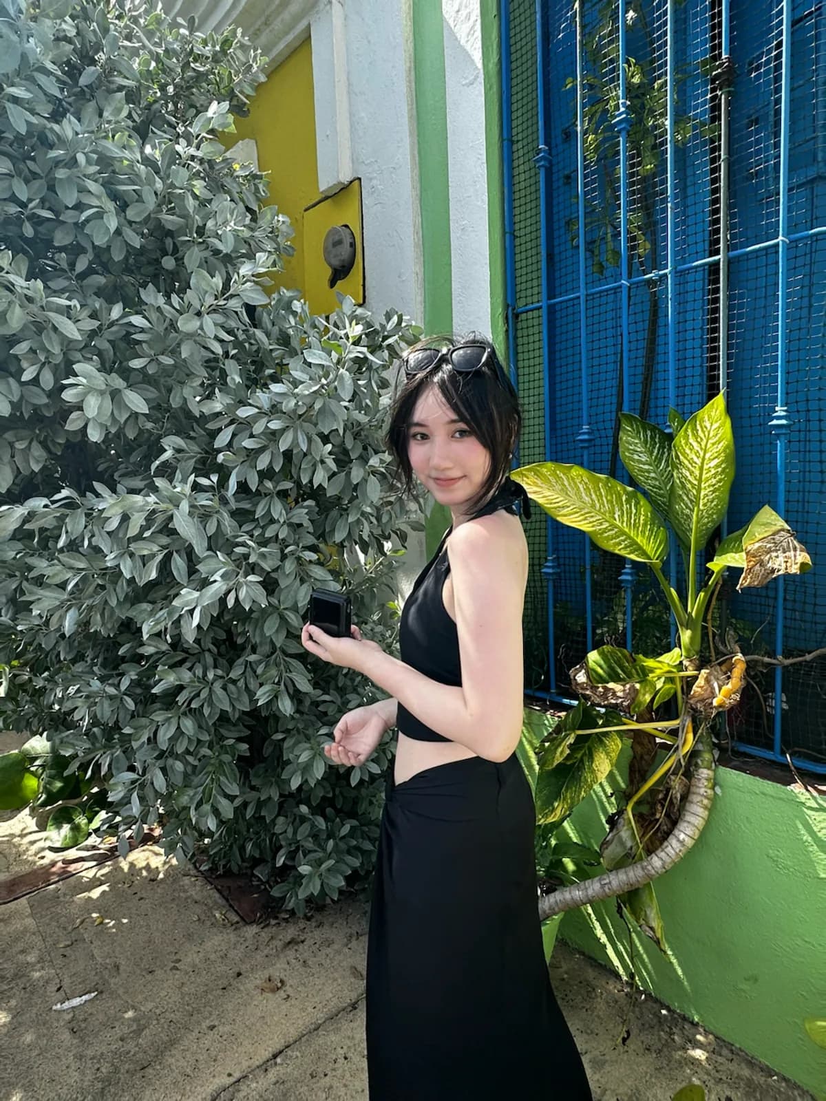 Ashley by a colorful garden while traveling