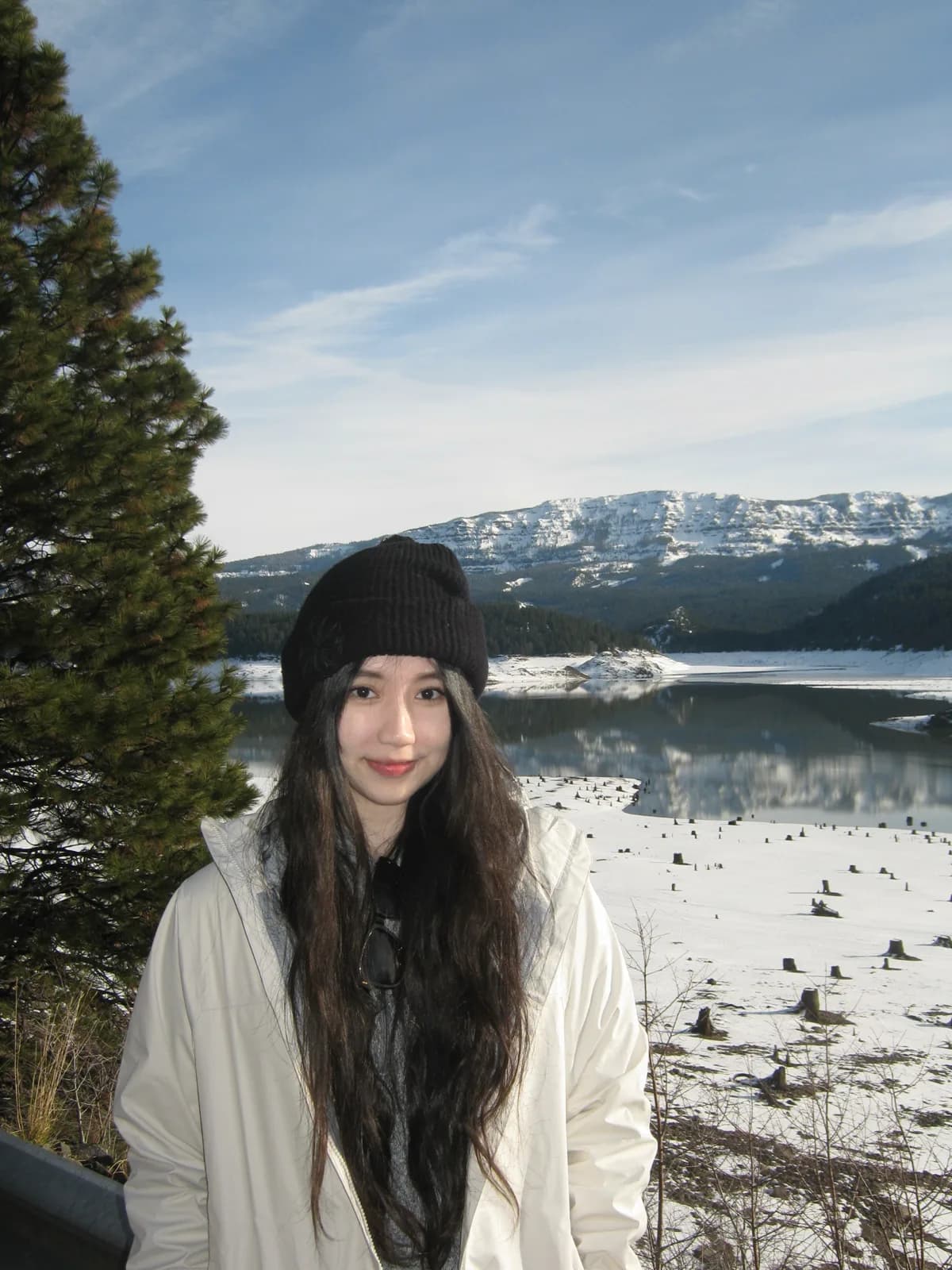Ashley by a snowy mountain lake